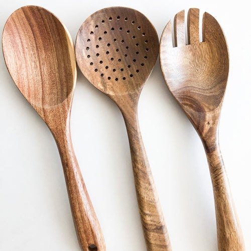Fenwick acacia wood kitchen utensil set, photographed on a warm neutral surface