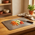 Titanium Cutting Board shown in a warm, cosy home setting