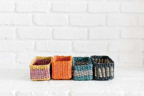 Halden woven seagrass tray with black band, photographed on a warm neutral surface